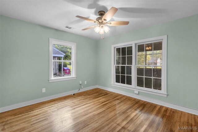 unfurnished room with ceiling fan and wood-type flooring