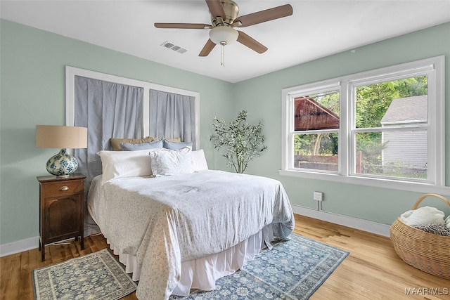 bedroom with ceiling fan and light hardwood / wood-style flooring