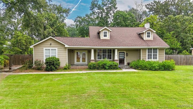 cape cod home featuring a front lawn