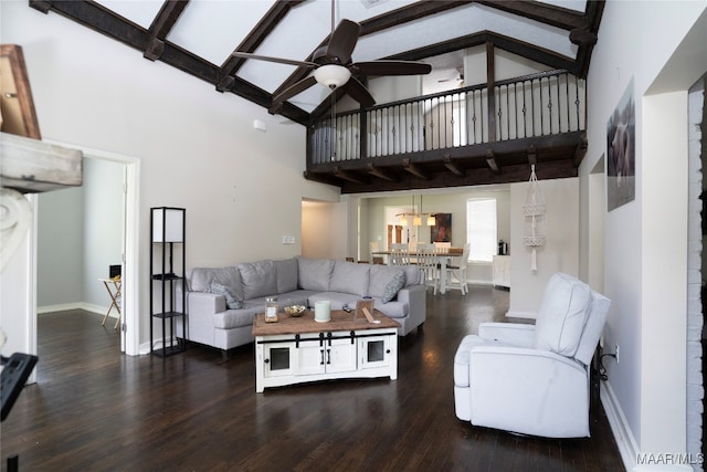 living room featuring ceiling fan, a towering ceiling, and wood-type flooring