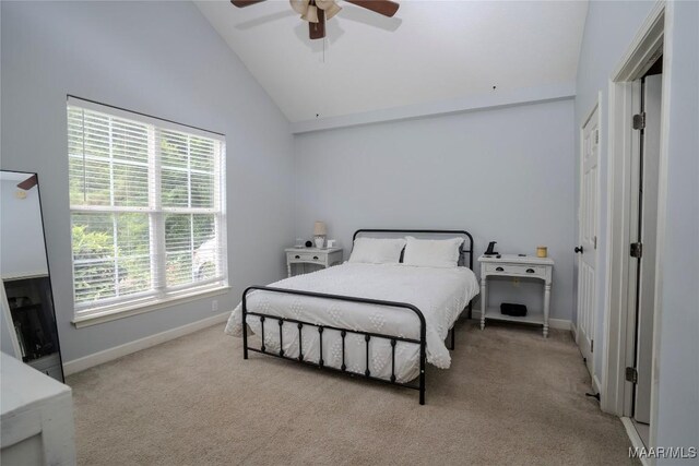 bedroom with ceiling fan, vaulted ceiling, and light colored carpet