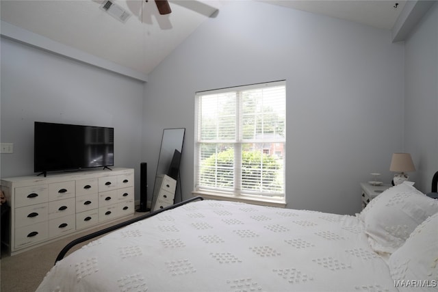 carpeted bedroom with ceiling fan and vaulted ceiling