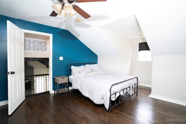 bedroom with ceiling fan, hardwood / wood-style flooring, and lofted ceiling