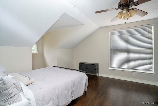 bedroom with ceiling fan, wood-type flooring, a textured ceiling, and lofted ceiling