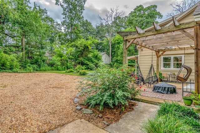 view of yard with a pergola and a patio