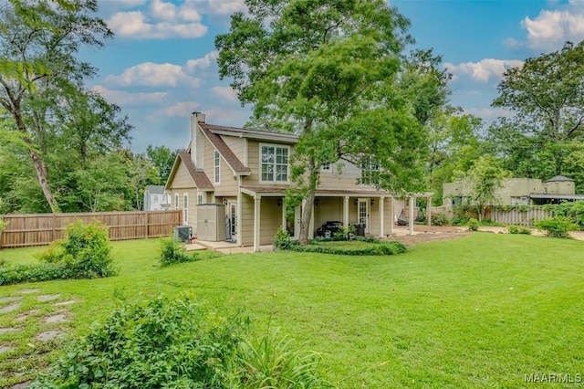 rear view of property featuring a yard