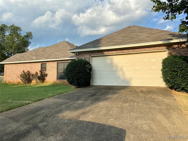 exterior space with a garage and a lawn