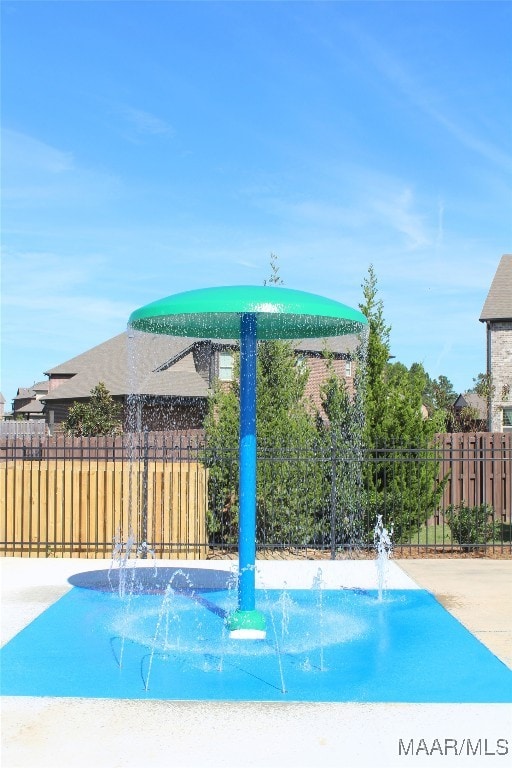 view of pool featuring fence