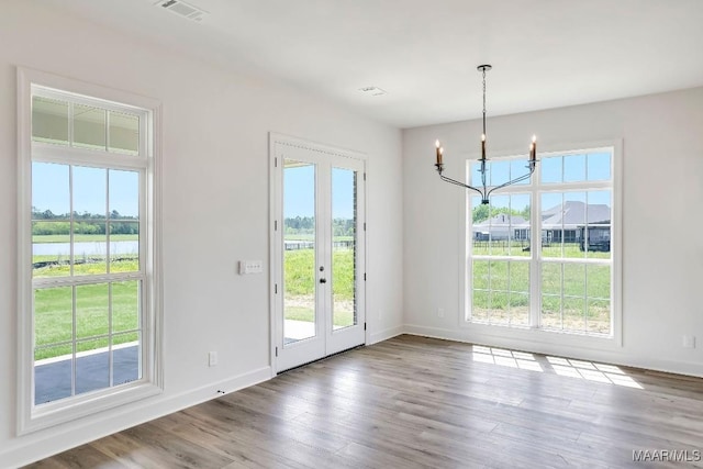 1415 Barret Park Way, Montgomery, AL 36117 - unfurnished dining area with a chandelier, healthy amount of natural light, wood finished floors, and baseboards