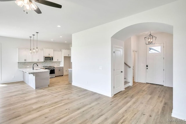 1415 Barret Park Way, Montgomery, AL 36117 - kitchen featuring stainless steel appliances, a peninsula, light countertops, white cabinetry, and light wood-style floors