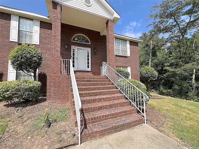 doorway to property with a yard