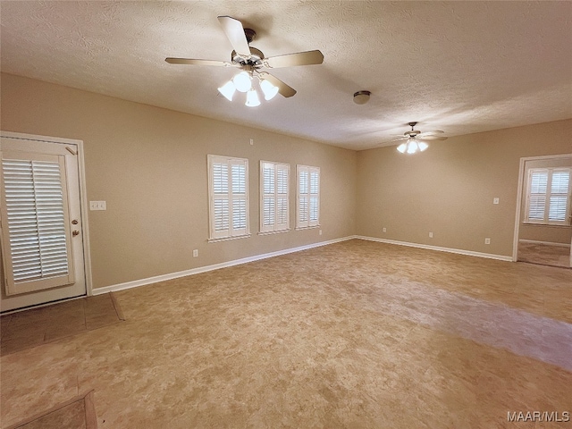 spare room with ceiling fan and a textured ceiling