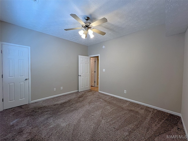 spare room with carpet flooring, a textured ceiling, and ceiling fan