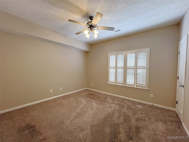 carpeted empty room with ceiling fan and a textured ceiling