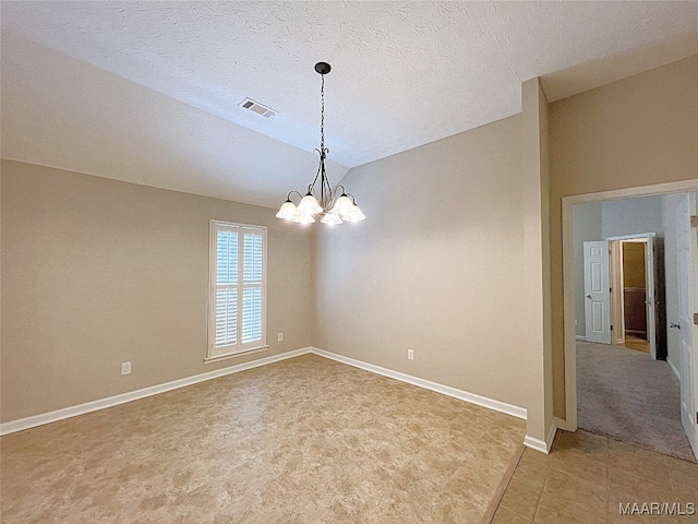 spare room featuring a notable chandelier, lofted ceiling, and a textured ceiling