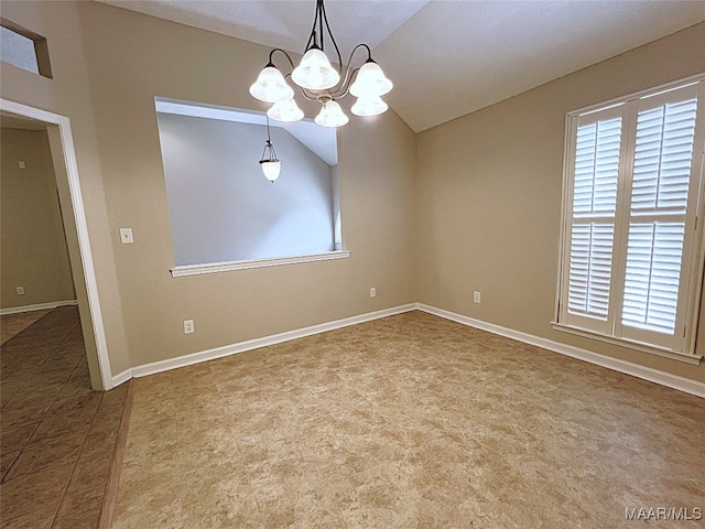 empty room featuring lofted ceiling and an inviting chandelier