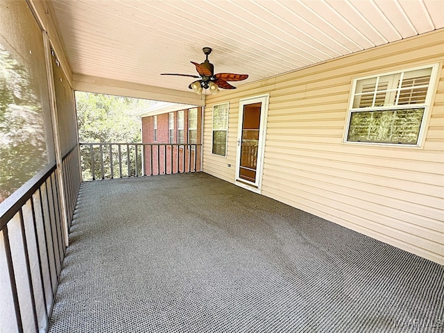 view of patio / terrace with a balcony and ceiling fan