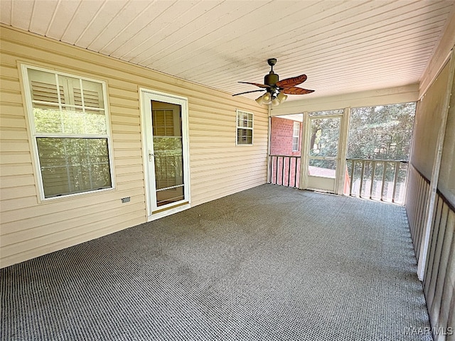 unfurnished sunroom with ceiling fan