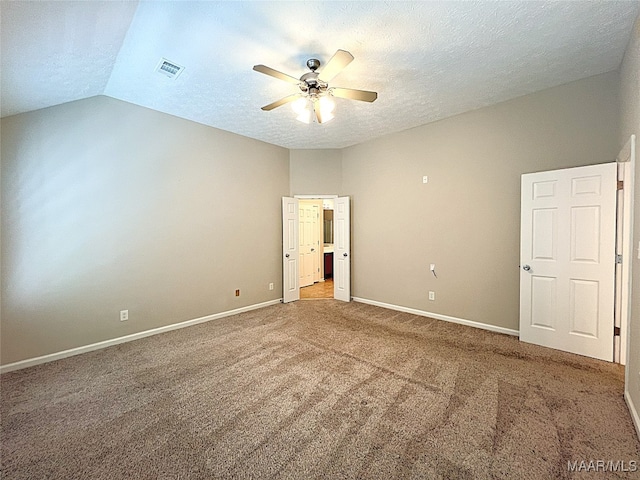 spare room with carpet, a textured ceiling, ceiling fan, and lofted ceiling