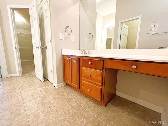 bathroom featuring tile patterned flooring and vanity