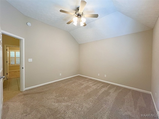 bonus room featuring carpet flooring, a textured ceiling, ceiling fan, and lofted ceiling