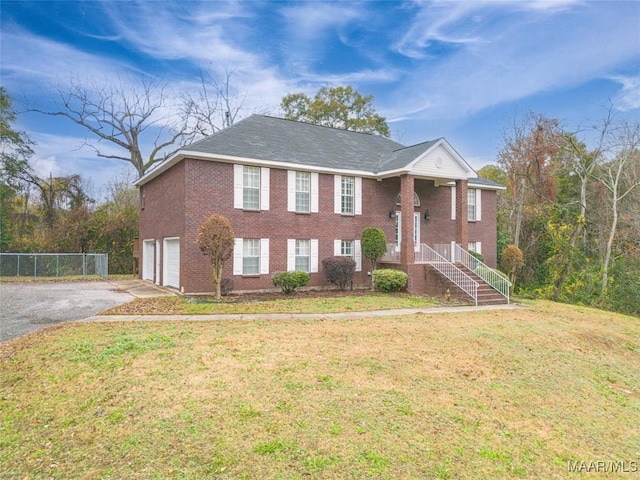 view of front facade featuring a front lawn and a garage