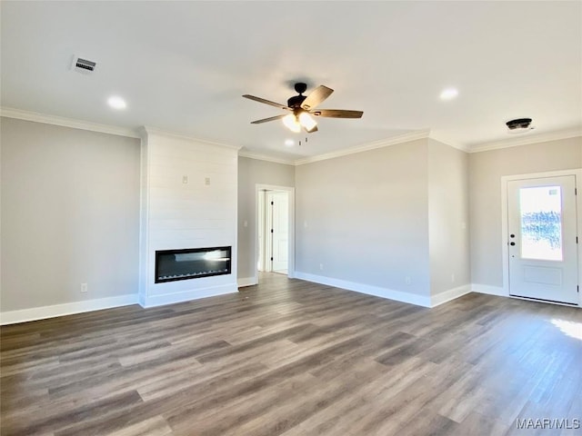 unfurnished living room featuring crown molding, ceiling fan, a large fireplace, and wood-type flooring