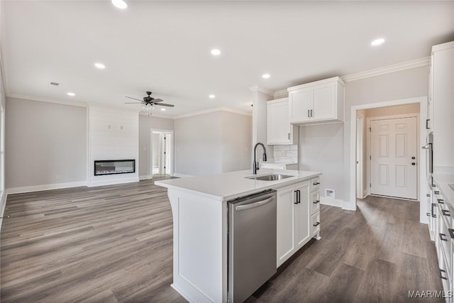 kitchen with stainless steel dishwasher, ceiling fan, sink, a center island with sink, and white cabinets