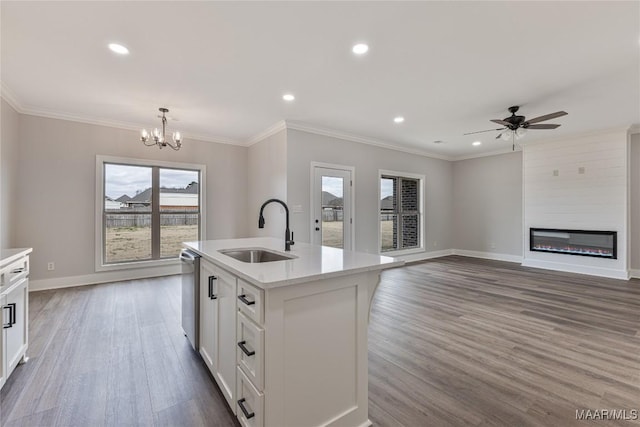 kitchen featuring white cabinetry, dishwasher, sink, an island with sink, and pendant lighting