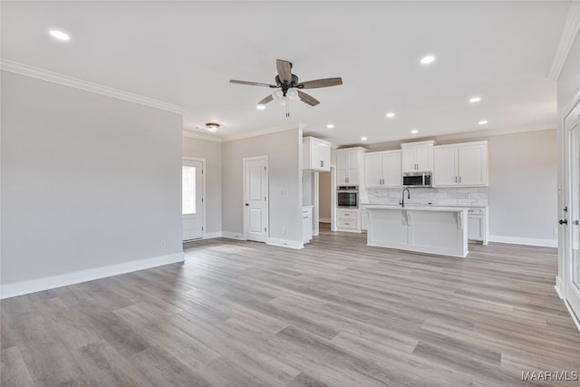 unfurnished living room with ceiling fan, sink, crown molding, and light wood-type flooring