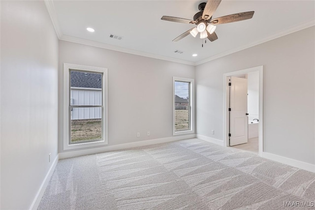 carpeted empty room featuring ceiling fan and ornamental molding