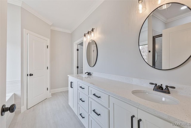 bathroom featuring vanity, a bathtub, and ornamental molding