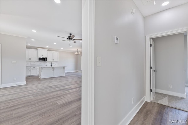 interior space with light hardwood / wood-style flooring and crown molding