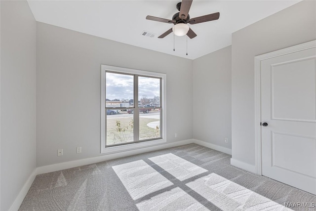 spare room with light carpet and ceiling fan