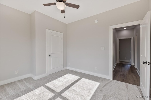 empty room with carpet floors and ceiling fan