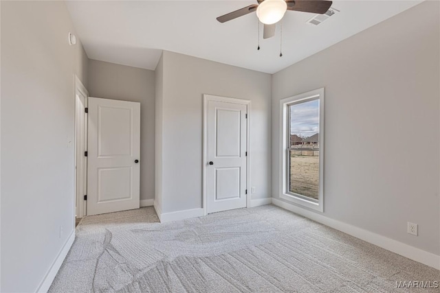 unfurnished bedroom featuring ceiling fan and light carpet