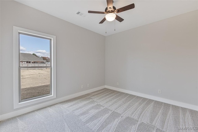 carpeted spare room with ceiling fan