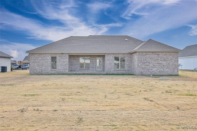 back of property featuring a lawn