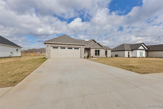 view of front of house featuring a front lawn and a garage