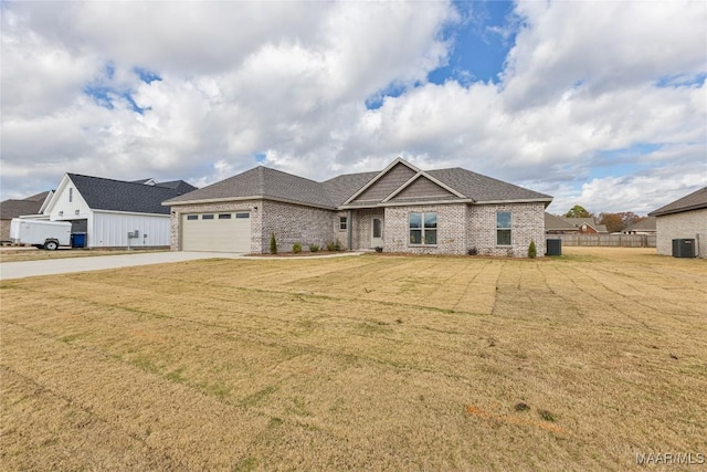 view of front of property featuring central AC unit, a garage, and a front yard