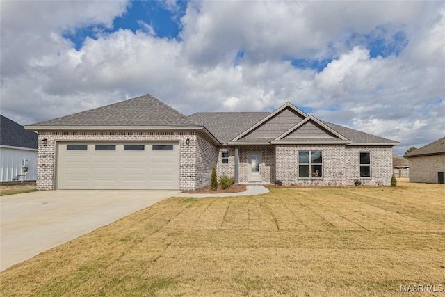 view of front of house featuring a garage and a front lawn