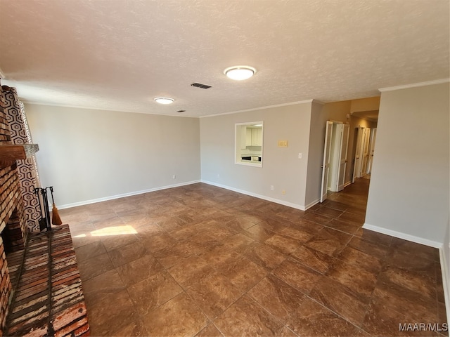 unfurnished living room with dark tile patterned flooring, crown molding, a textured ceiling, and a fireplace