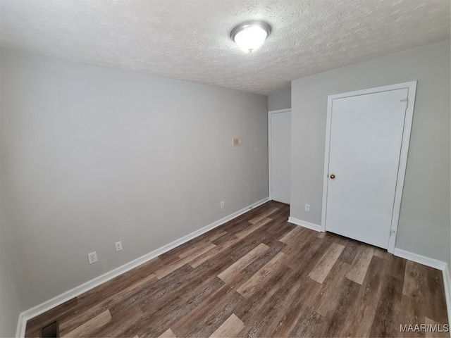 unfurnished bedroom with a textured ceiling and hardwood / wood-style floors