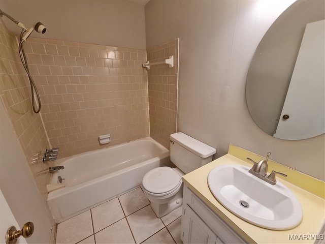 full bathroom with tiled shower / bath, toilet, tile patterned floors, and vanity