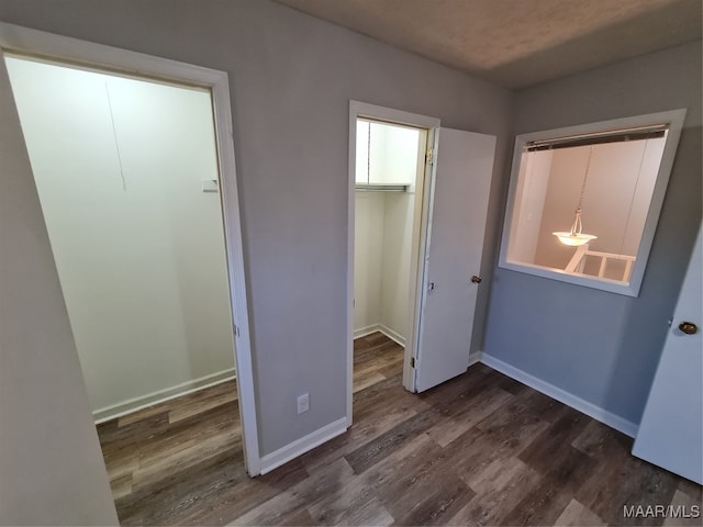 unfurnished bedroom with hardwood / wood-style floors and a closet