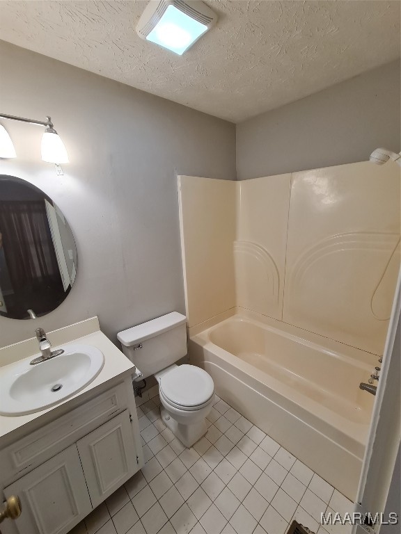 full bathroom with toilet, shower / bathtub combination, vanity, tile patterned floors, and a textured ceiling