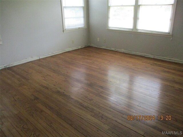 unfurnished room featuring dark hardwood / wood-style flooring