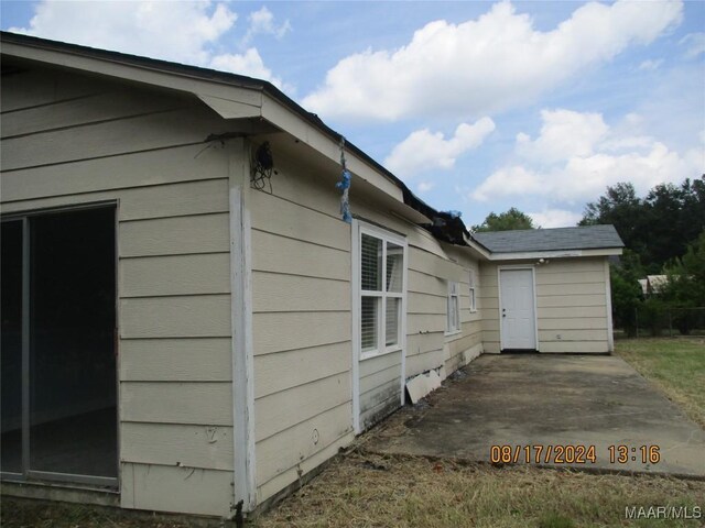 view of side of home with a patio