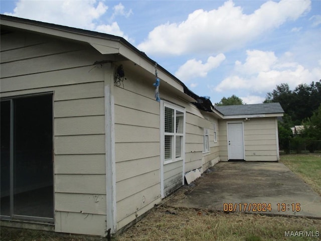 view of property exterior with a patio area