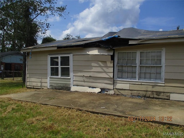 view of side of property featuring a patio